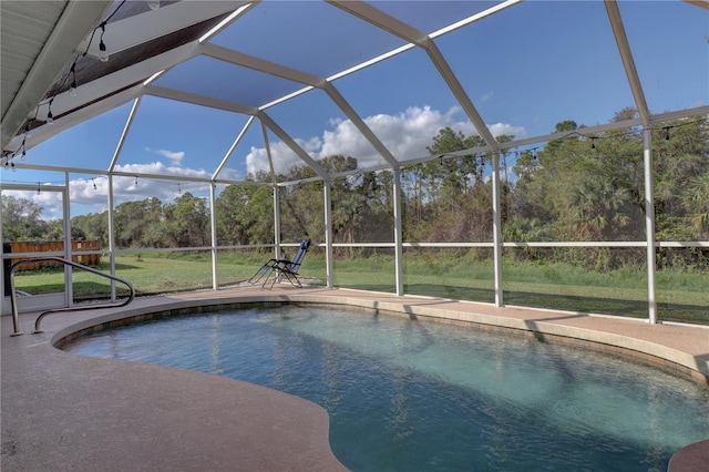 view of pool with a lanai and a lawn