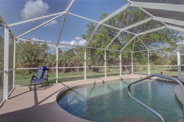 view of pool with a patio area and a lanai