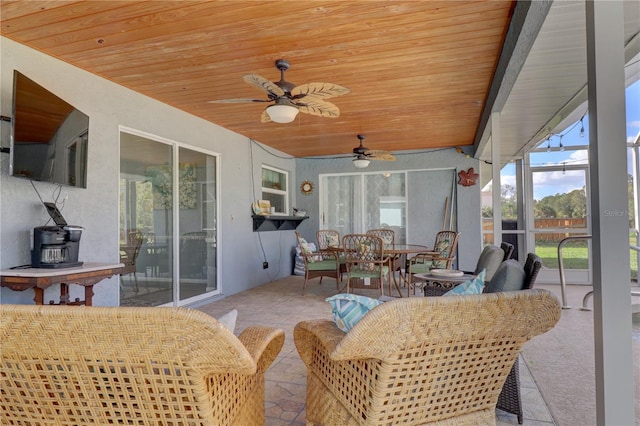 sunroom with wood ceiling, ceiling fan, and a healthy amount of sunlight