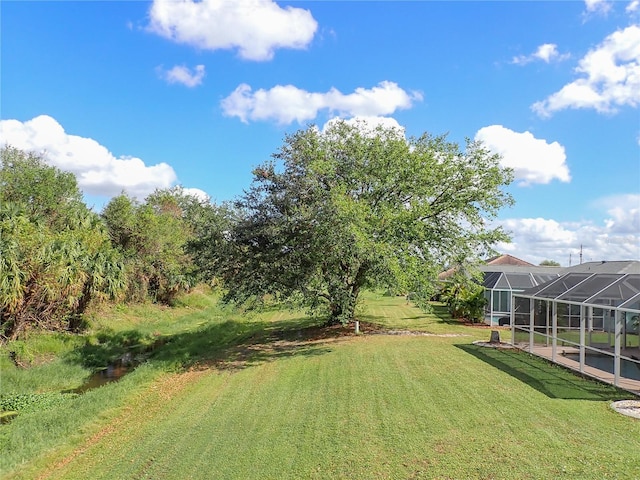 view of yard featuring glass enclosure