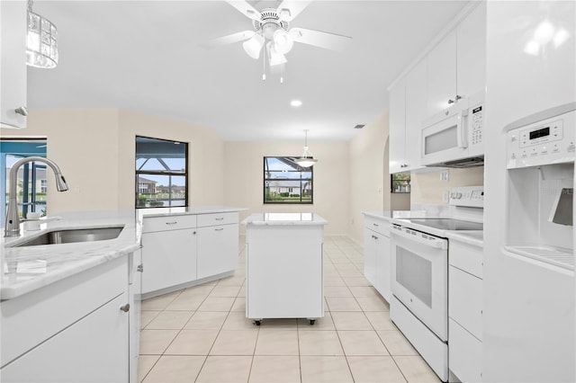 kitchen featuring a center island, white appliances, sink, white cabinets, and pendant lighting