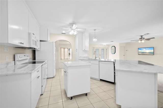 kitchen featuring white appliances, sink, white cabinets, kitchen peninsula, and pendant lighting