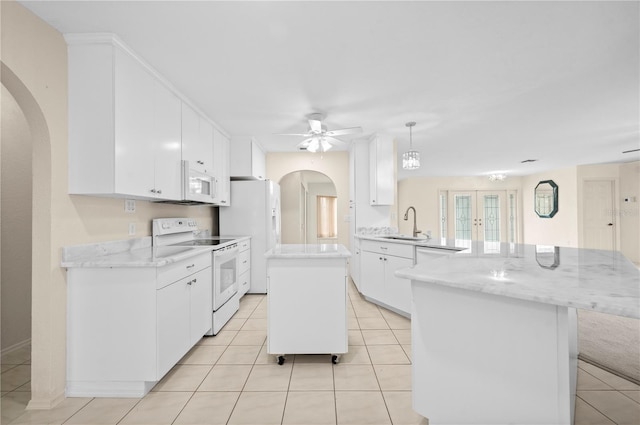 kitchen with pendant lighting, white cabinetry, white appliances, and kitchen peninsula