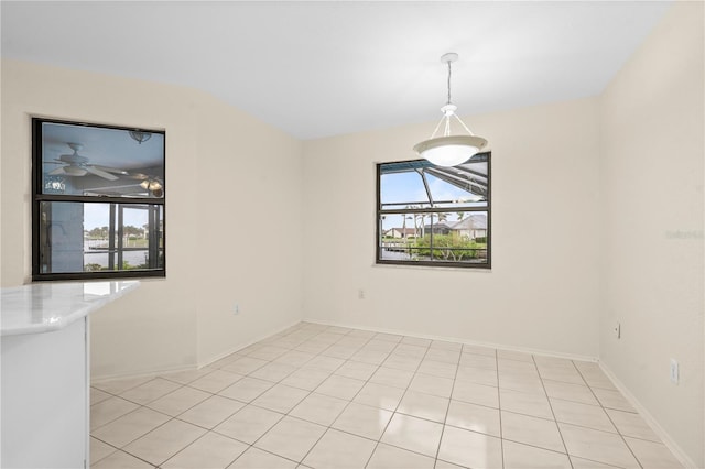 unfurnished dining area featuring light tile patterned flooring