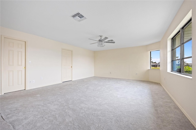 spare room with light colored carpet and ceiling fan