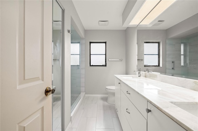 bathroom featuring toilet, vanity, and a tile shower