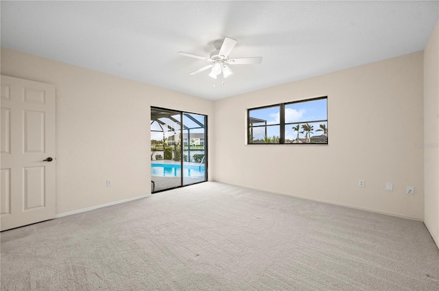 empty room with ceiling fan and light colored carpet