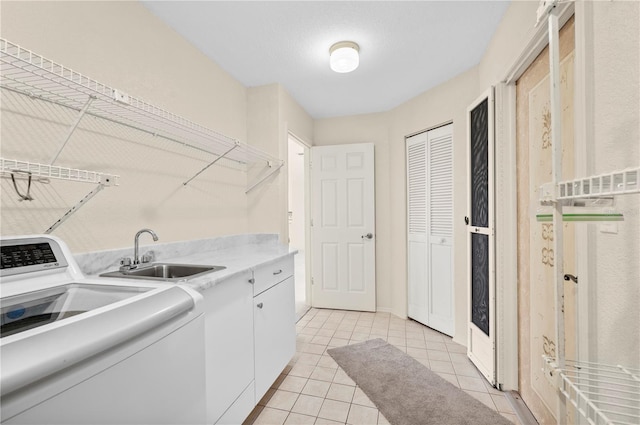 laundry area with cabinets, sink, light tile patterned floors, and washer / dryer