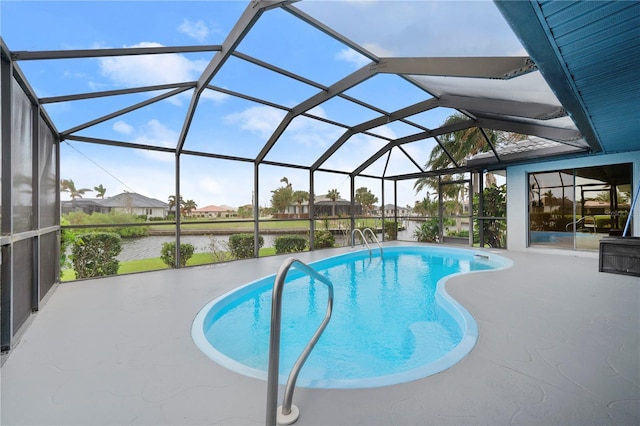 view of pool featuring glass enclosure, a water view, and a patio