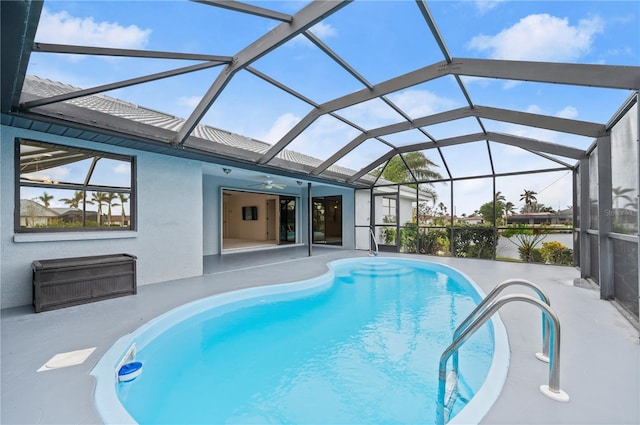 view of pool with a patio and glass enclosure