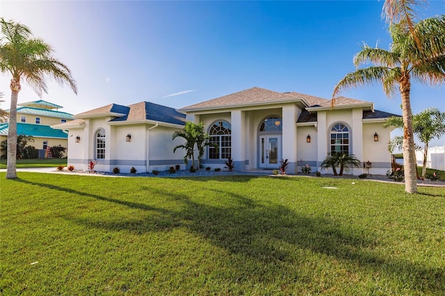 17183 Ohara Dr, Port Charlotte, FL 33948 - mediterranean / spanish-style house with stucco siding, a front yard, and french doors