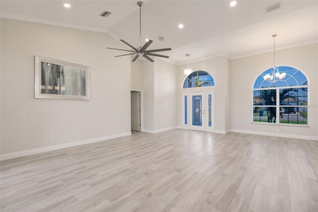17183 Ohara Dr, Port Charlotte, FL 33948 - unfurnished living room with a chandelier, light wood-type flooring, recessed lighting, crown molding, and vaulted ceiling