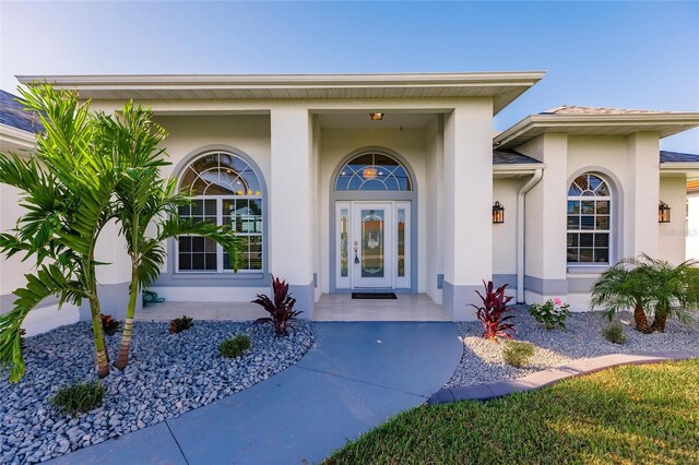17183 Ohara Dr, Port Charlotte, FL 33948 - doorway to property with stucco siding and covered porch