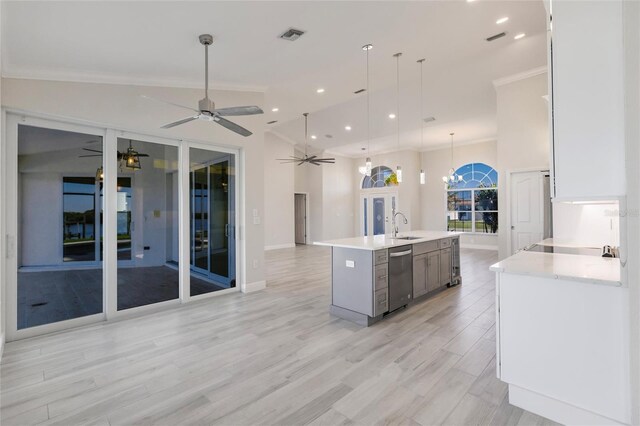 17183 Ohara Dr, Port Charlotte, FL 33948 - kitchen featuring crown molding, stainless steel dishwasher, ceiling fan, light countertops, and open floor plan