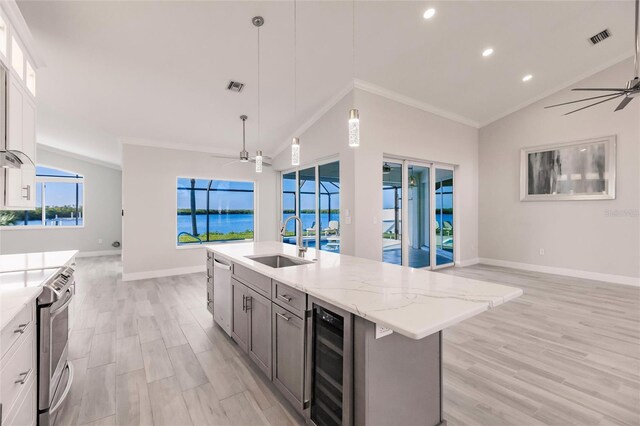 17183 Ohara Dr, Port Charlotte, FL 33948 - kitchen featuring a sink, wine cooler, open floor plan, crown molding, and recessed lighting