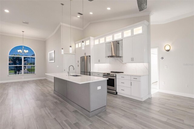 17183 Ohara Dr, Port Charlotte, FL 33948 - kitchen featuring stainless steel appliances, wall chimney exhaust hood, a sink, high vaulted ceiling, and a chandelier