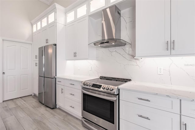 17183 Ohara Dr, Port Charlotte, FL 33948 - kitchen with stainless steel appliances, island exhaust hood, light stone counters, and white cabinets
