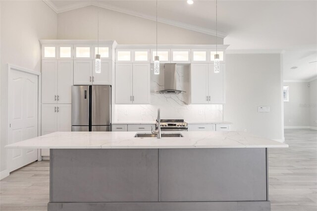 17183 Ohara Dr, Port Charlotte, FL 33948 - kitchen featuring appliances with stainless steel finishes, wall chimney exhaust hood, a sink, a kitchen island with sink, and white cabinetry