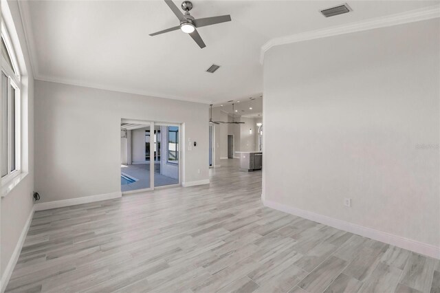 17183 Ohara Dr, Port Charlotte, FL 33948 - unfurnished living room with ornamental molding, a ceiling fan, light wood-style floors, baseboards, and lofted ceiling
