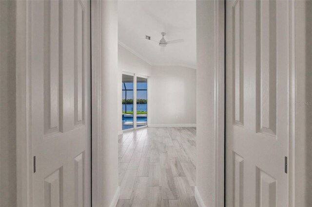 17183 Ohara Dr, Port Charlotte, FL 33948 - hall featuring crown molding, light wood-style flooring, baseboards, a water view, and vaulted ceiling