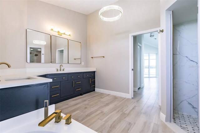 17183 Ohara Dr, Port Charlotte, FL 33948 - full bathroom with vanity, wood finished floors, a marble finish shower, and baseboards