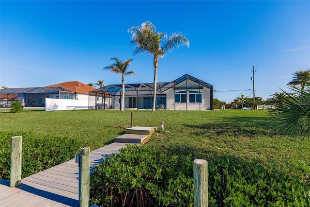 17183 Ohara Dr, Port Charlotte, FL 33948 - dock area featuring a lawn and glass enclosure