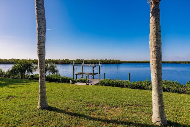 17183 Ohara Dr, Port Charlotte, FL 33948 - dock area with boat lift, a lawn, and a water view