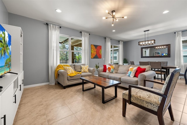 tiled living room featuring a notable chandelier