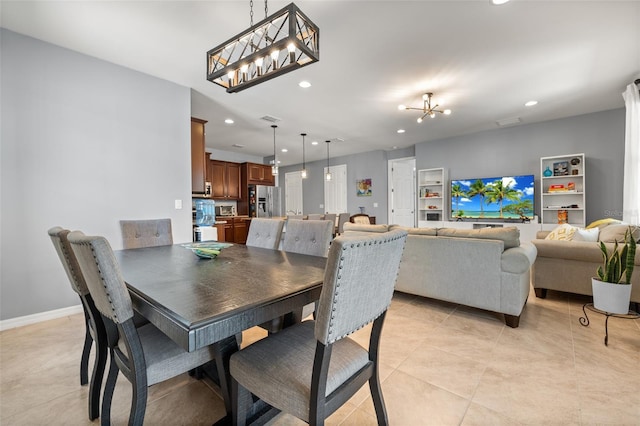 dining room with an inviting chandelier and light tile patterned flooring