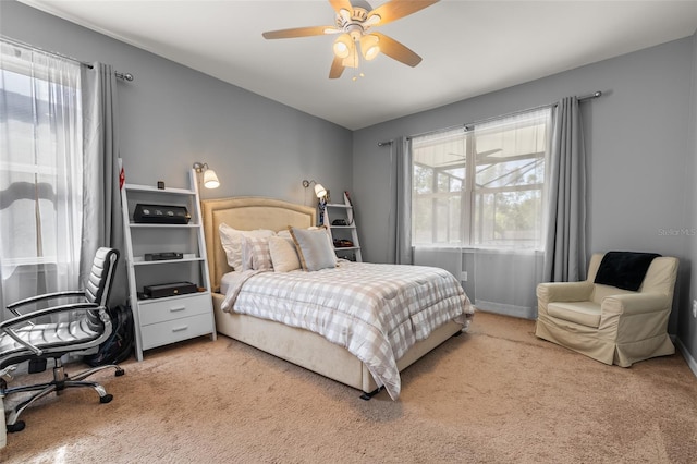 bedroom with light colored carpet and ceiling fan