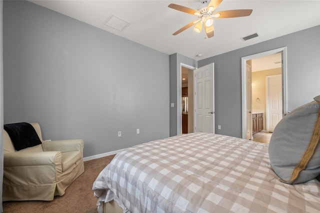 carpeted bedroom featuring ceiling fan and ensuite bath