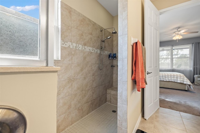 bathroom featuring ceiling fan, tile patterned floors, and a tile shower