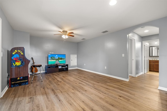 living room with ceiling fan and light hardwood / wood-style flooring