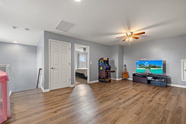 living room featuring hardwood / wood-style flooring and ceiling fan