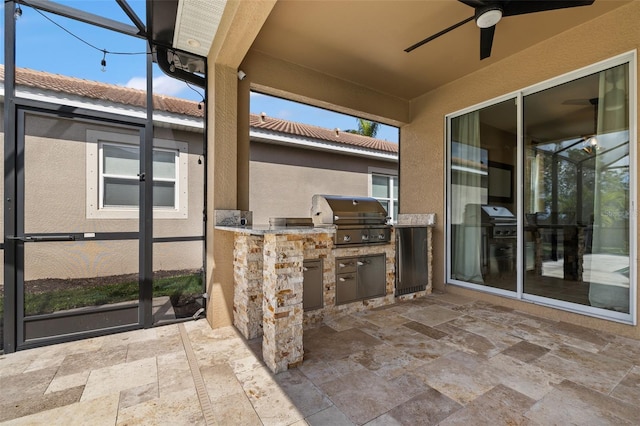 view of patio / terrace with ceiling fan, area for grilling, and a grill