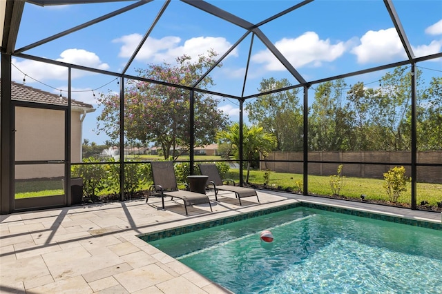 view of pool with a lanai and a patio