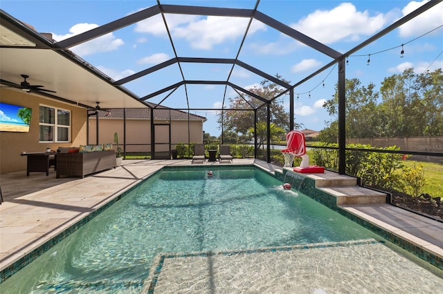 view of swimming pool featuring a patio, outdoor lounge area, a lanai, pool water feature, and ceiling fan