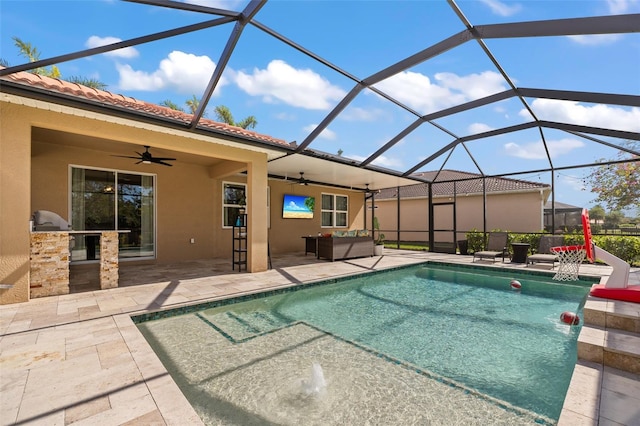 view of pool featuring pool water feature, a lanai, ceiling fan, exterior kitchen, and a patio