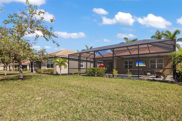 rear view of house featuring a patio area, glass enclosure, and a lawn