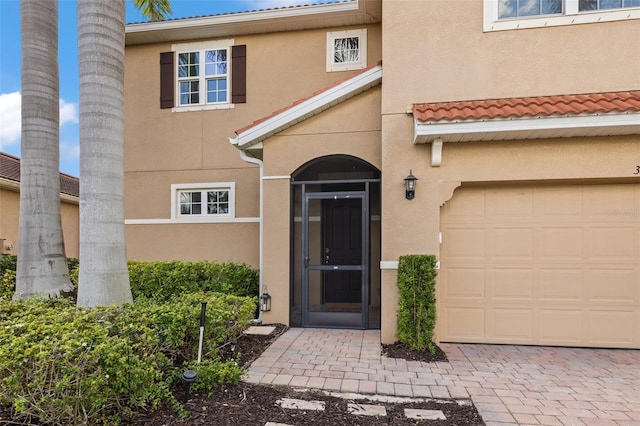 doorway to property with a garage