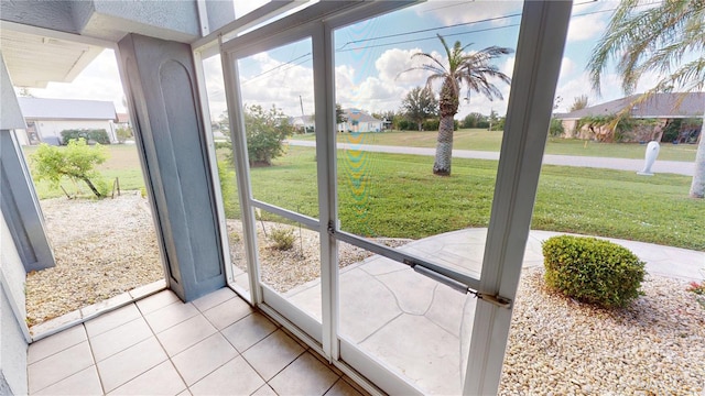 doorway to outside with light tile patterned floors