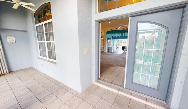 view of exterior entry featuring ceiling fan