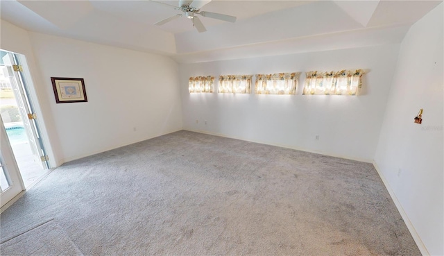 carpeted spare room with plenty of natural light and ceiling fan