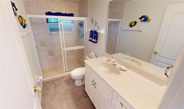 bathroom with vanity, a shower with shower door, and toilet