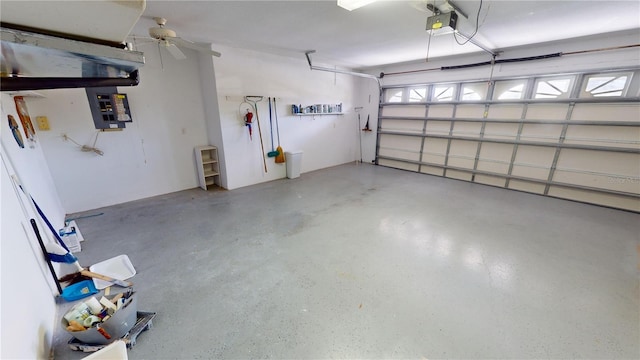 garage featuring ceiling fan, electric panel, and a garage door opener