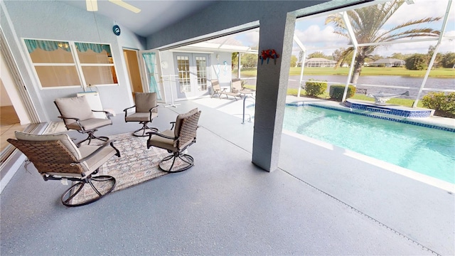 view of swimming pool featuring a patio area, a lanai, and french doors