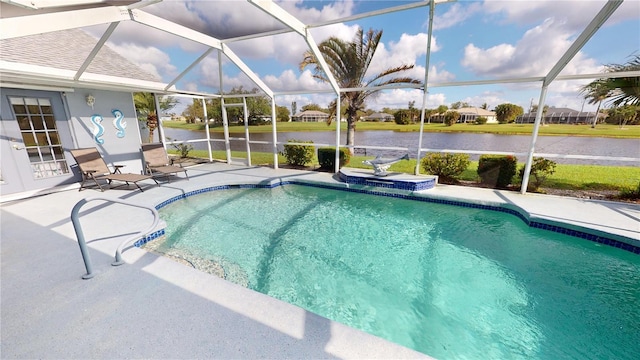 view of swimming pool with glass enclosure, a water view, and a patio