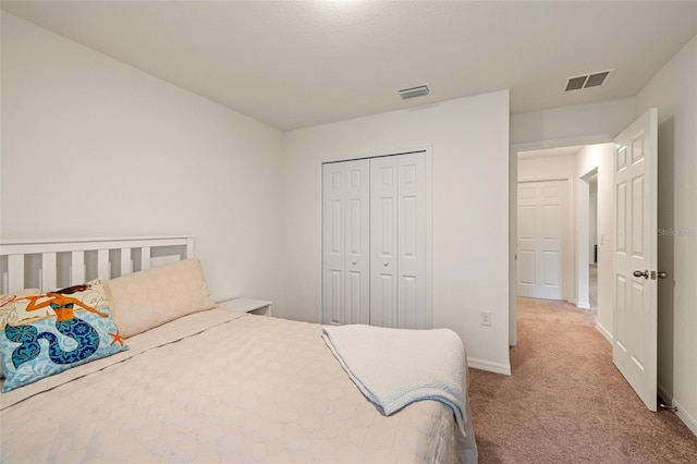 bedroom with carpet and a closet