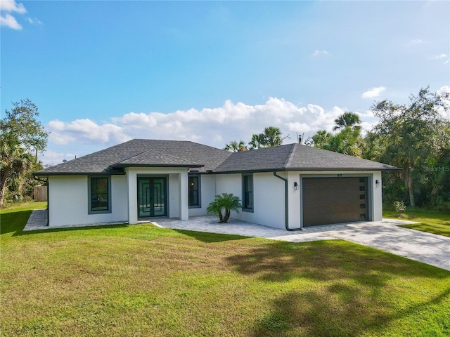 view of front facade with french doors, a front lawn, and a garage