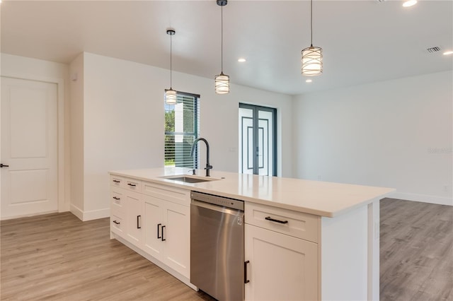 kitchen with white cabinetry, dishwasher, light hardwood / wood-style flooring, decorative light fixtures, and a kitchen island with sink